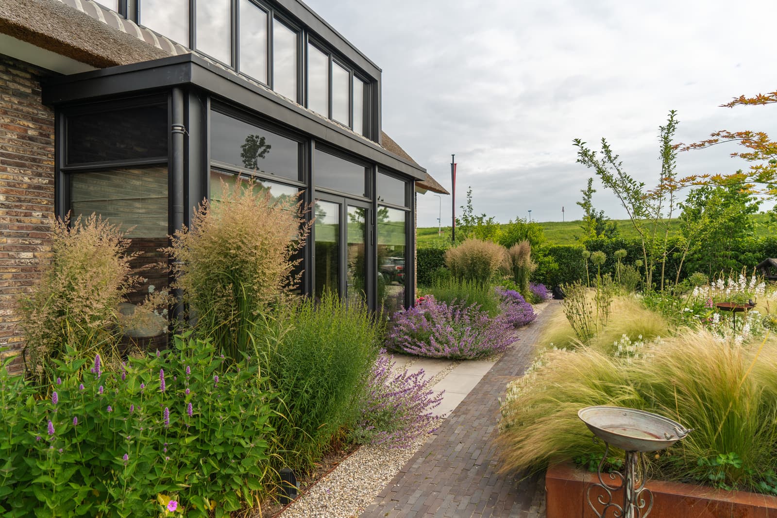 Aangelegde landelijke tuin met zwembad in Doornenburg door Van Rijbroek Hoveniers — foto 8 van 20